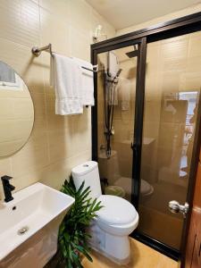 a bathroom with a toilet and a sink at Tagaytay Hampton Villa in Tagaytay