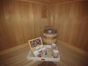 a corner of a sauna with a barrel and a shelf at Hotel Rosa Serenella in Bardonecchia