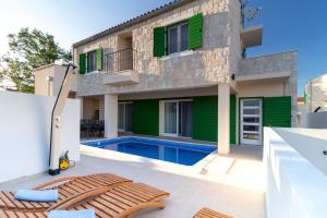 a house with a swimming pool in front of it at Corte villas & apartments - AE1043 in Privlaka