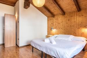 Postel nebo postele na pokoji v ubytování The Lodge Monte Bondone