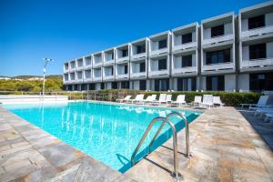 a swimming pool in front of a building at Apollo Resort in Agia Marina Aegina