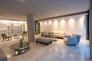 a living room with a couch and a table at Apollo Resort in Agia Marina Aegina