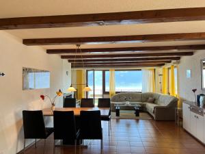 ein Wohnzimmer mit einem Sofa und einem Tisch in der Unterkunft Brissago: Casa Collinetta H in Brissago
