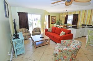 a living room with a red couch and a table at Stunning 8 BR, New Updates, Walk to Beach Bars, Main Street in Myrtle Beach