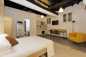 a bedroom with a bed and a table and chairs at Trastevere Suites & Spa in Rome