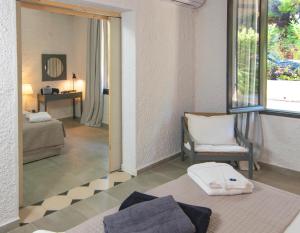 a living room with a couch and a mirror at Apollo Resort in Agia Marina Aegina