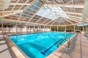 a large swimming pool with a glass ceiling at Salt Pond -- 23 Topsail Village in Bethany Beach