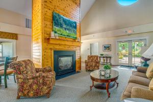 sala de estar con chimenea, sofá y sillas en Salt Pond -- 10 Spinnaker Vilage, en Bethany Beach