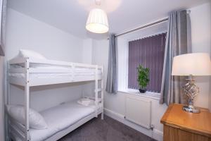 a bedroom with a bunk bed and a window at The Westminster Suite in Plymouth