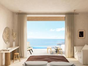 パラダイスビーチにあるEden View Suites & Villasの海の景色を望むベッドルーム1室