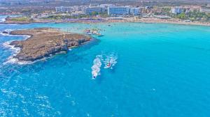 an aerial view of two boats in the ocean at Chrysomare Beach Hotel & Resort in Ayia Napa