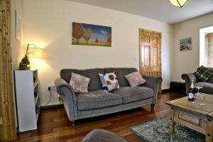 a living room with a couch and a table at Village Lodge - Carlingford in Carlingford