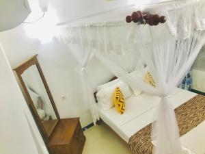 Postel nebo postele na pokoji v ubytování Sahana Sri Villa