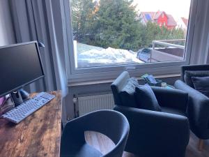 ブラウンラーゲにあるModerne, ruhige Ferienwohnung in Braunlage Harz inkl WLAN & Netflixのデスク(コンピュータモニター、椅子付)が備わる客室です。