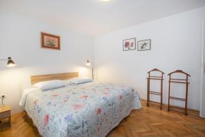 a bedroom with a bed and two racks in it at Apartman Vito in Labin