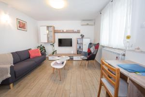 a living room with a couch and a table at Apartman Vito in Labin