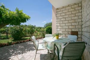 a patio with a table and chairs on a patio at Apartman Vito in Labin
