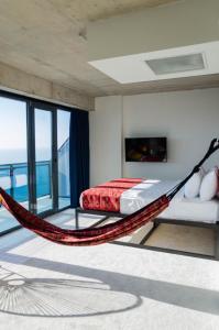 a hammock bed in a bedroom with a view at Kartuli Hotel in Batumi