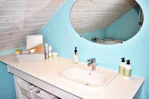 a bathroom with a sink and a mirror at Viking Surf Cottage in Klitmøller +12 photos