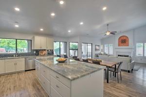 a kitchen and living room with a table and chairs at Luxurious Chandler Oasis with Heated Pool and Hot Tub! in Chandler