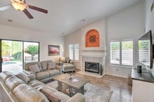 a living room with a couch and a fireplace at Luxurious Chandler Oasis with Heated Pool and Hot Tub! in Chandler