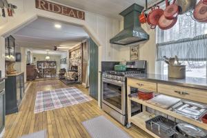 a kitchen with a stove and a counter top at Charming Sutton Cottage Walk to Lake and Farm! 