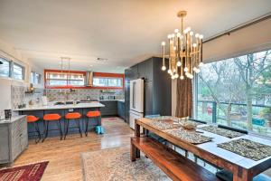 a kitchen with a wooden table and a dining room at Eclectic Austin Bungalow Central Location! in Austin