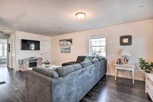 a living room with a large couch and a television at Bright and Airy Condo - Walk to Ortley Beach! in Seaside Heights