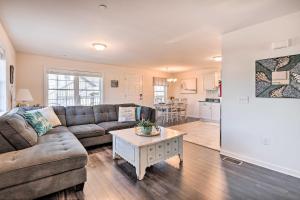 a living room with a couch and a table at Bright and Airy Condo - Walk to Ortley Beach! in Seaside Heights