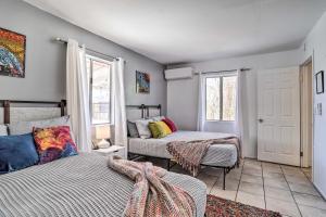 a bedroom with two beds and a window at Cali Desert Oasis with Hot Tub and Mtn Views! in Twentynine Palms