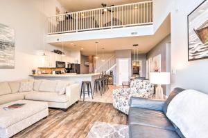 a living room with two couches and a kitchen at Scenic Family Condo with Game Room and Boat Dock! in Camdenton