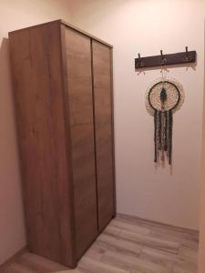 a room with a wooden door and a dream catcher on the wall at Restauracja Hotel 4u in Kańczuga