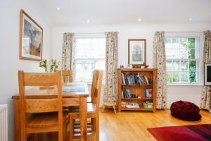 a dining room with a table and a book shelf at Edinburgh Mews Apartment in Edinburgh