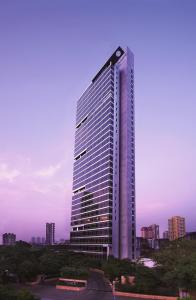 a tall building with a lot of windows at Four Seasons Hotel Mumbai in Mumbai