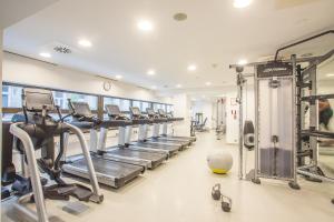 a gym with a row of treadmills and machines at InterContinental Budapest, an IHG Hotel in Budapest