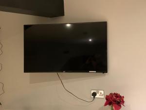 a flat screen tv hanging on a wall at Studio Apartment - Entire Lower Ground Floor - Only 7 Mins Walk Kings Cross St Pancras Station in London