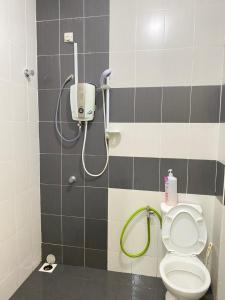 a bathroom with a shower with a toilet at Azzalea Homes 5 @ Golden Hills Cameron Highlands in Brinchang +18 photos