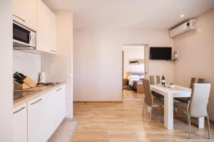 a kitchen and dining room with a table and chairs at Apartments Anka with Seaview in Vrsi
