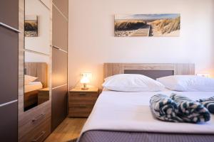 a bedroom with two beds and a view of a beach at Apartments Anka with Seaview in Vrsi