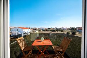 a table and chairs on a balcony with a view at Apartments Anka with Seaview in Vrsi