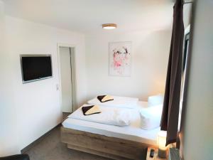 En eller flere senge i et værelse på Pfefferstübchen Ferienwohnung Schanzenblick