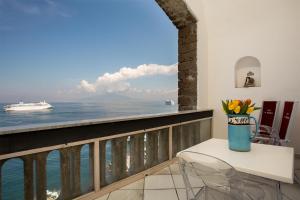 a balcony with a table and a vase of flowers at Villa La Terrazza Suites in Sorrento