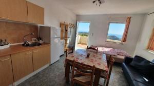 a kitchen with a table and a dining room at Finca Esperanza Costa del Sol in Sayalonga