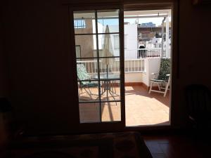 an open door to a balcony with a table and chairs at Casa Angelus + in Águilas
