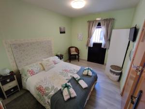 a bedroom with a bed with bows on it at Las Cigüeñas de San Cristóbal in San Cristóbal de Segovia