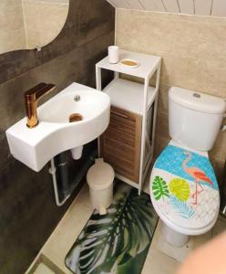 a bathroom with a sink and a toilet at Bungalow d'une chambre avec jardin clos et wifi a Fort de France in Fort-de-France