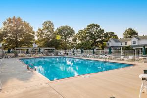 a large swimming pool with chairs and tables at Mallard Lakes -- 38287 Cardinal #139 in Selbyville