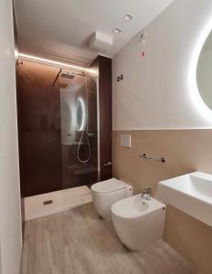 a bathroom with a shower and a toilet and a sink at Brezza Marina in Porto Recanati