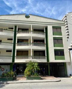 a white and green building with a balcony at Apartamento Rodadero in Gaira