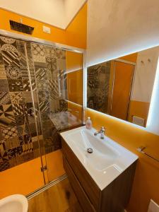 a bathroom with a sink and a shower at La casa di Grace in Savona